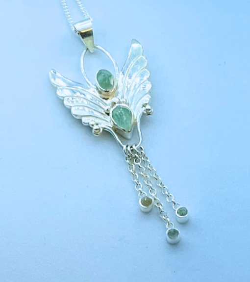 beautiful green tourmaline gemstones in a angel pendant