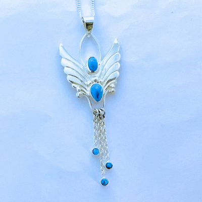 Blue turquoise in this lovely angel pendant with three moving drops each with a turquoise stone in